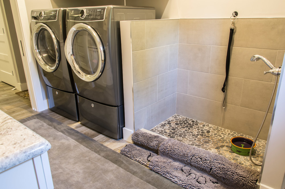 Immagine di una lavanderia multiuso chic di medie dimensioni con top in granito, pareti beige, pavimento con piastrelle in ceramica, lavatrice e asciugatrice affiancate, pavimento marrone e top beige