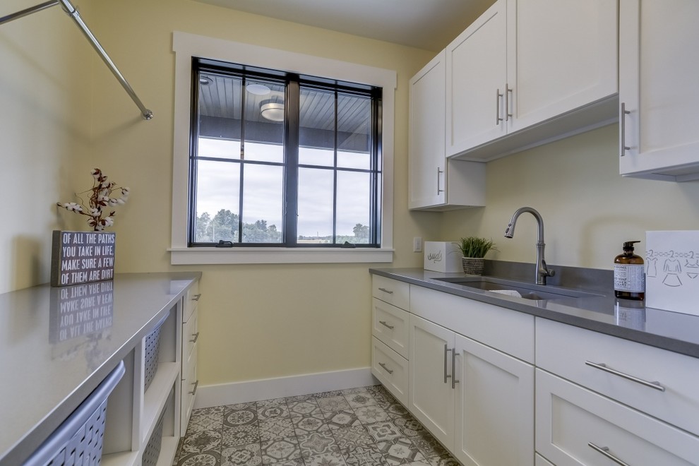 Mid-sized cottage galley ceramic tile and multicolored floor dedicated laundry room photo in Chicago with an undermount sink, recessed-panel cabinets, white cabinets, quartz countertops, yellow walls and gray countertops