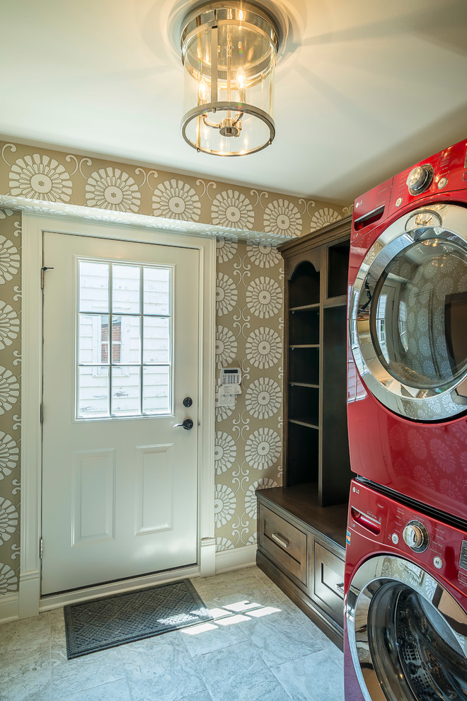 This is an example of a small traditional single-wall utility room in Chicago with shaker cabinets, dark wood cabinets, beige walls, porcelain flooring and a stacked washer and dryer.