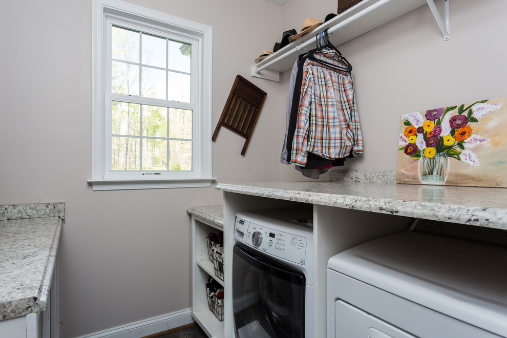 Photo of a medium sized classic galley separated utility room in DC Metro with an utility sink, white cabinets, granite worktops, beige walls, medium hardwood flooring, a side by side washer and dryer and brown floors.