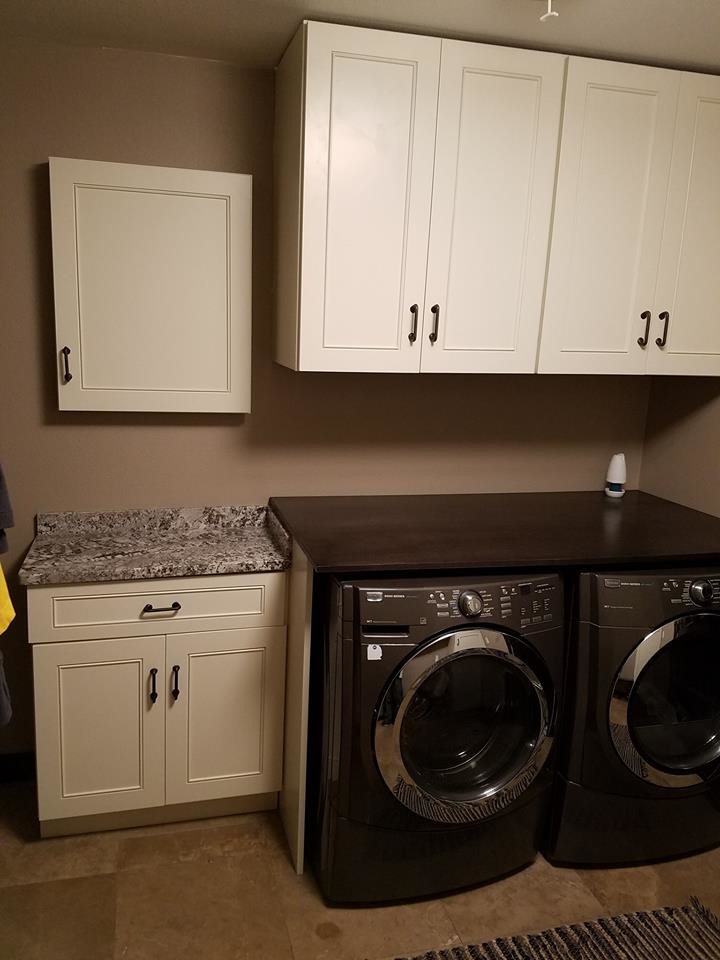 Photo of a medium sized farmhouse single-wall utility room in Other with shaker cabinets, white cabinets, granite worktops, vinyl flooring, a side by side washer and dryer and beige floors.