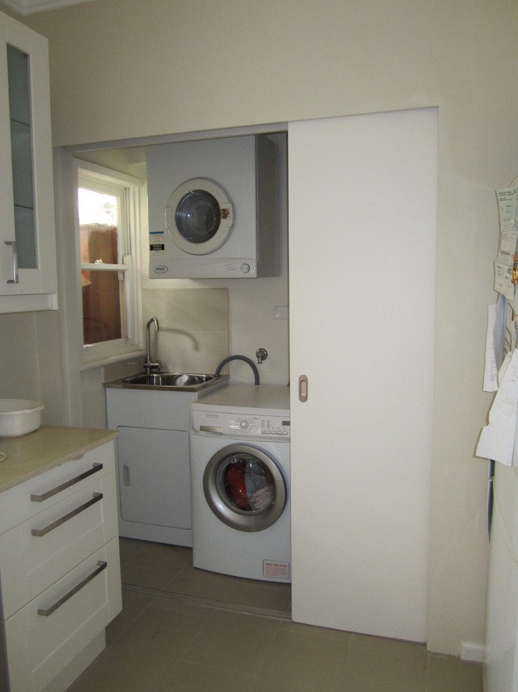 Einzeiliger, Kleiner Klassischer Hauswirtschaftsraum mit Waschmaschinenschrank, weißer Wandfarbe und Keramikboden in Sydney