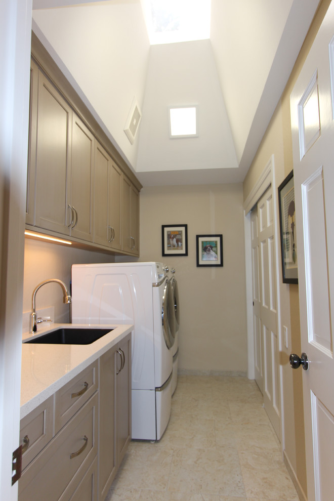 Inspiration for a medium sized classic single-wall separated utility room in San Francisco with beige walls, porcelain flooring, beige floors, a submerged sink, recessed-panel cabinets, beige cabinets, engineered stone countertops, a side by side washer and dryer and white worktops.