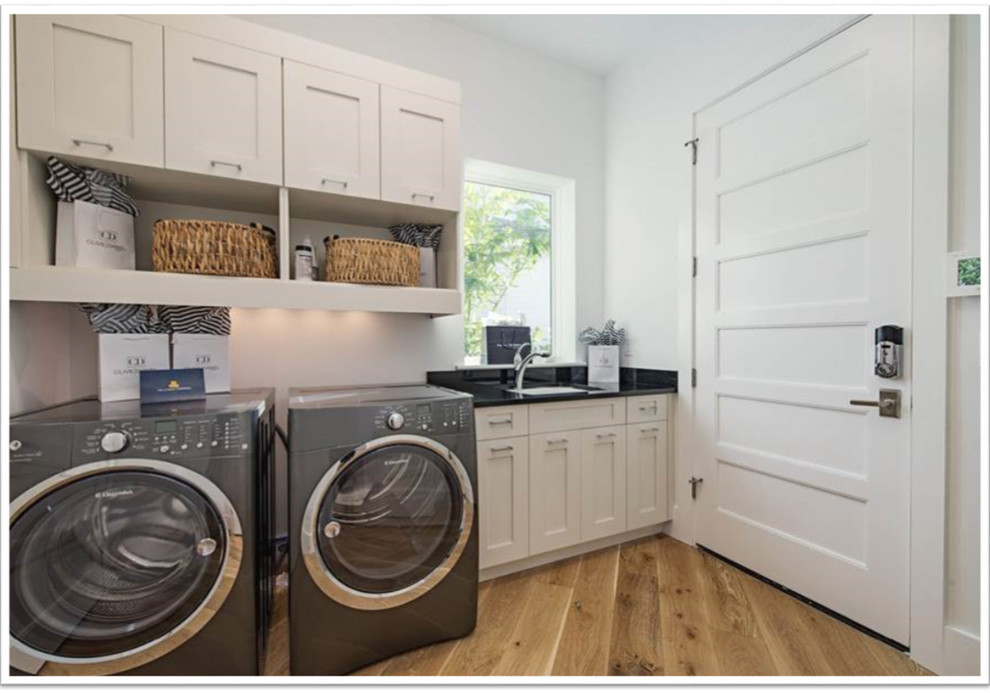 Design ideas for a medium sized beach style galley separated utility room in Miami with a submerged sink, shaker cabinets, granite worktops, white walls, medium hardwood flooring and a side by side washer and dryer.