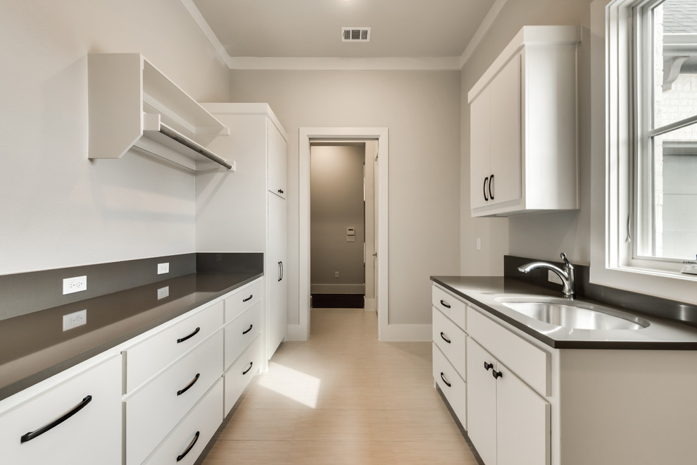 This is an example of a large traditional galley separated utility room in Dallas with a submerged sink, flat-panel cabinets, white cabinets, engineered stone countertops, grey walls, ceramic flooring and a side by side washer and dryer.