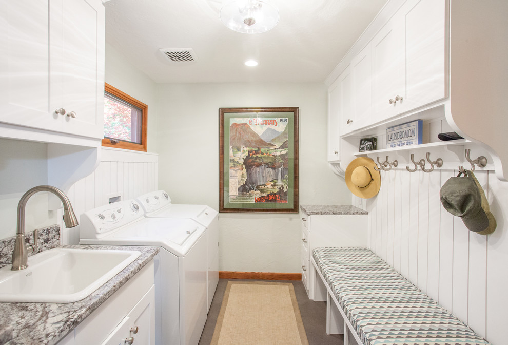 This is an example of a small bohemian galley utility room in Other with a built-in sink, shaker cabinets, white cabinets, granite worktops, porcelain flooring, a side by side washer and dryer, grey floors and white walls.