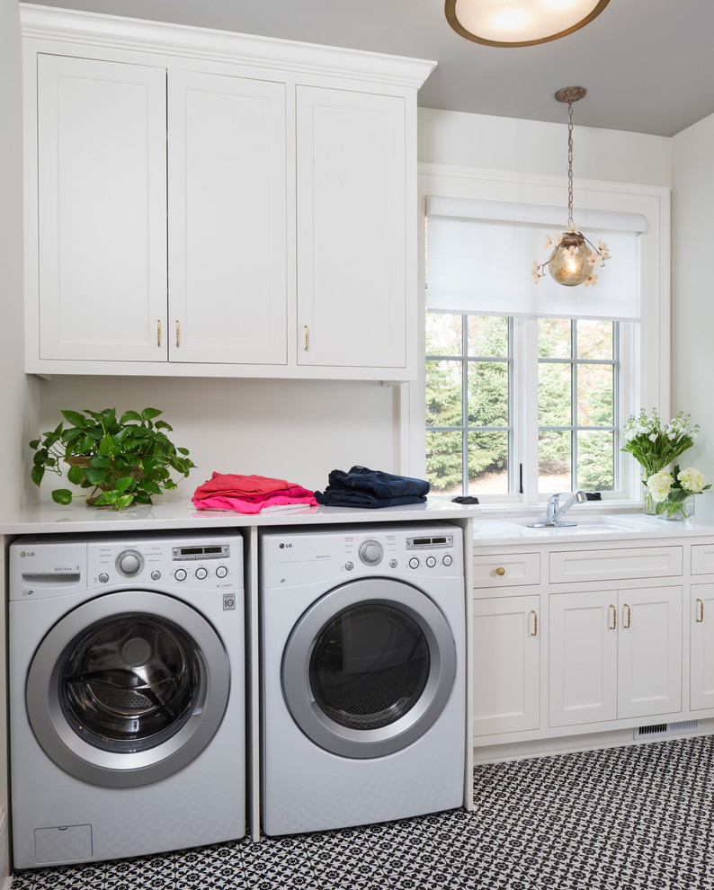 Inspiration for a timeless porcelain tile dedicated laundry room remodel in Minneapolis with quartz countertops, white walls and a side-by-side washer/dryer