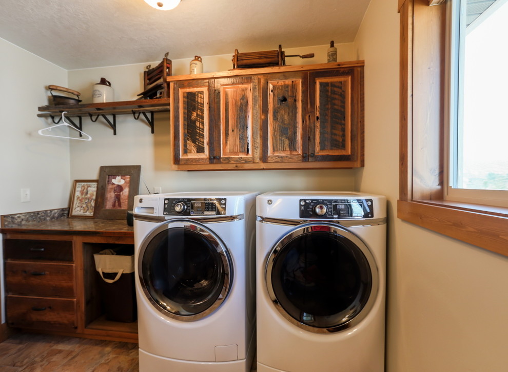 Inspiration for a mid-sized rustic single-wall dedicated laundry room remodel in Other with raised-panel cabinets, distressed cabinets, white walls and a side-by-side washer/dryer