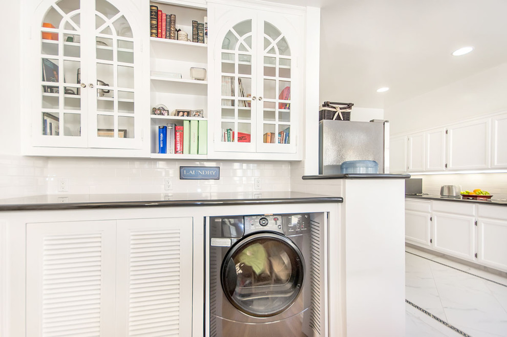 This is an example of a classic utility room in San Francisco with white cabinets.