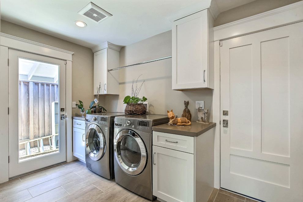 Medium sized classic single-wall separated utility room in San Francisco with shaker cabinets, white cabinets, a side by side washer and dryer and beige floors.