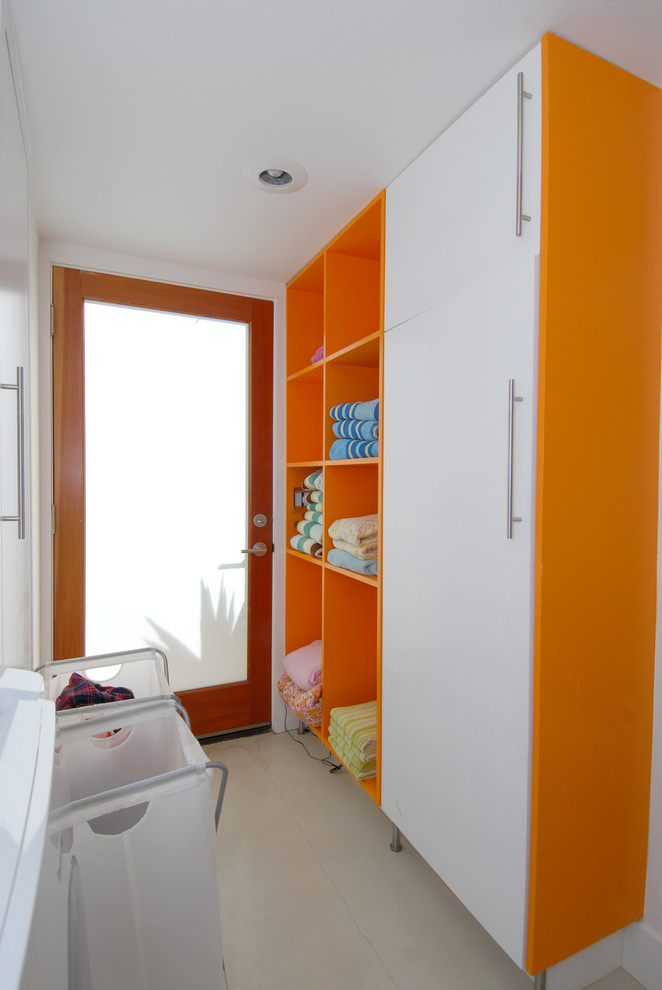 Photo of a contemporary galley utility room in Orange County with open cabinets and orange cabinets.