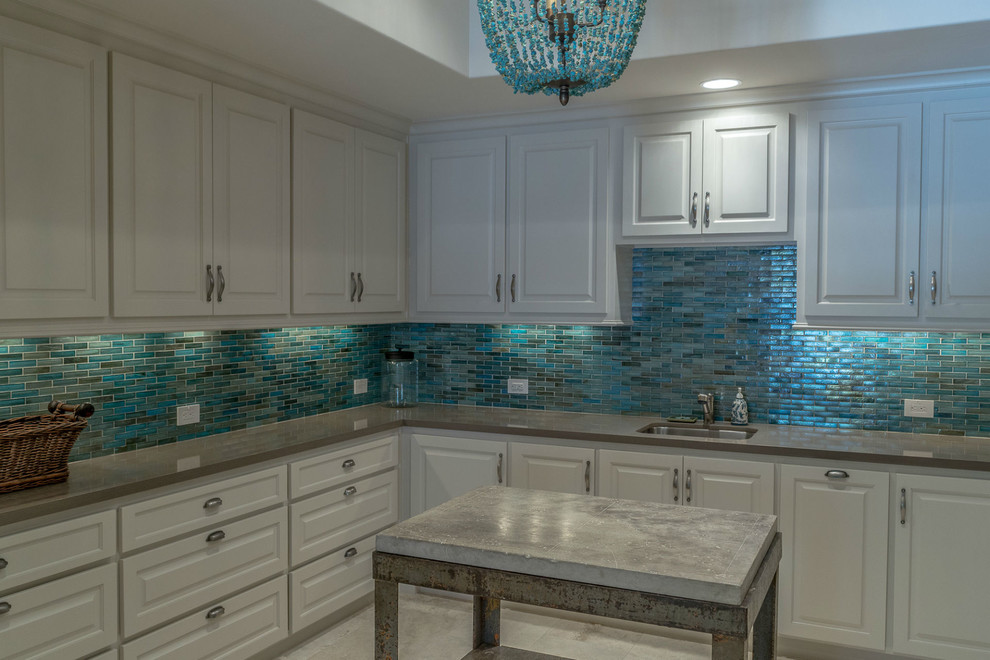 Example of a large southwest u-shaped marble floor dedicated laundry room design in Dallas with an undermount sink, raised-panel cabinets, white cabinets, quartz countertops and blue walls