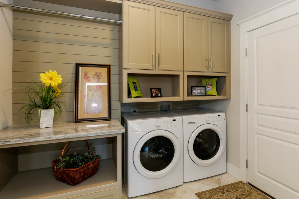 Example of a small transitional travertine floor and beige floor laundry room design in Other with beaded inset cabinets, beige cabinets, granite countertops, gray walls, a side-by-side washer/dryer and beige countertops