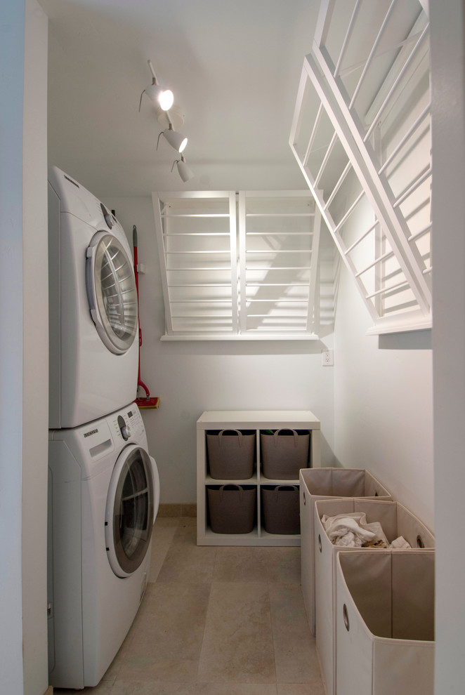 Dedicated laundry room - contemporary single-wall dedicated laundry room idea in San Francisco with a stacked washer/dryer