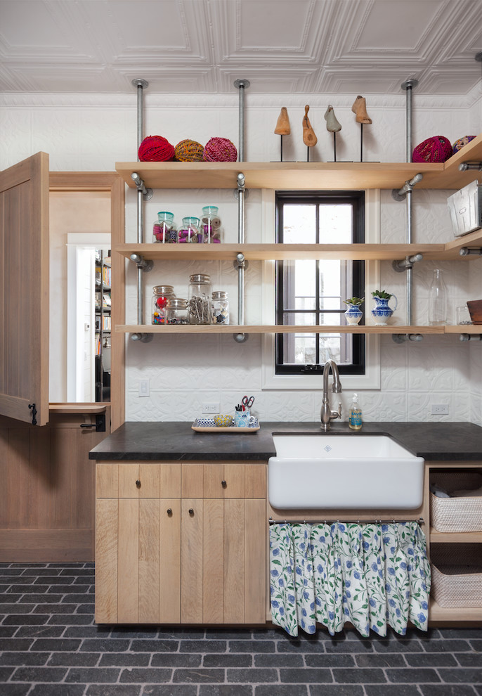 Inspiration for a medium sized farmhouse utility room in Phoenix with a belfast sink, flat-panel cabinets, light wood cabinets and white walls.