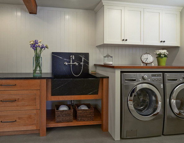 Design ideas for a modern utility room in Seattle with a belfast sink, wood worktops, white walls and a side by side washer and dryer.