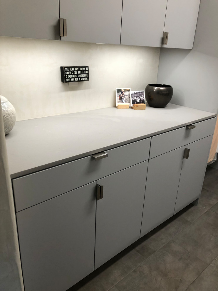 Dedicated laundry room - mid-sized contemporary galley gray floor dedicated laundry room idea in Other with an undermount sink, flat-panel cabinets, gray cabinets, beige walls, a side-by-side washer/dryer and gray countertops