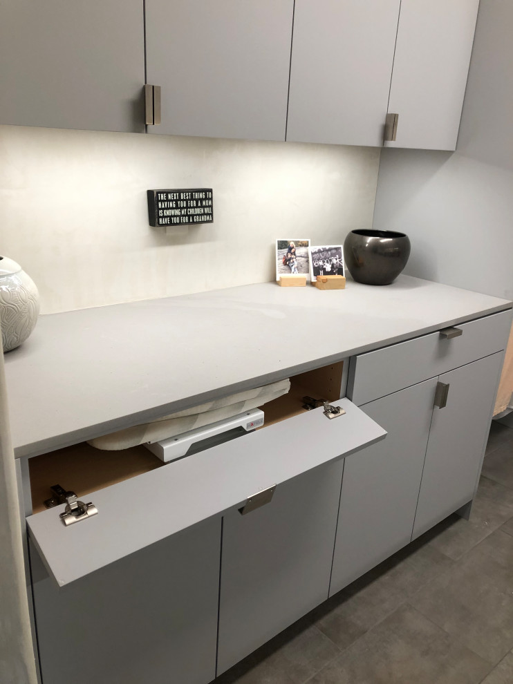 Mid-sized trendy galley gray floor dedicated laundry room photo in Other with an undermount sink, flat-panel cabinets, gray cabinets, beige walls, a side-by-side washer/dryer and gray countertops