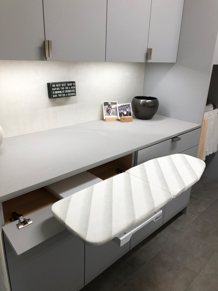 Inspiration for a mid-sized contemporary galley gray floor dedicated laundry room remodel in Other with an undermount sink, flat-panel cabinets, gray cabinets, beige walls, a side-by-side washer/dryer and gray countertops
