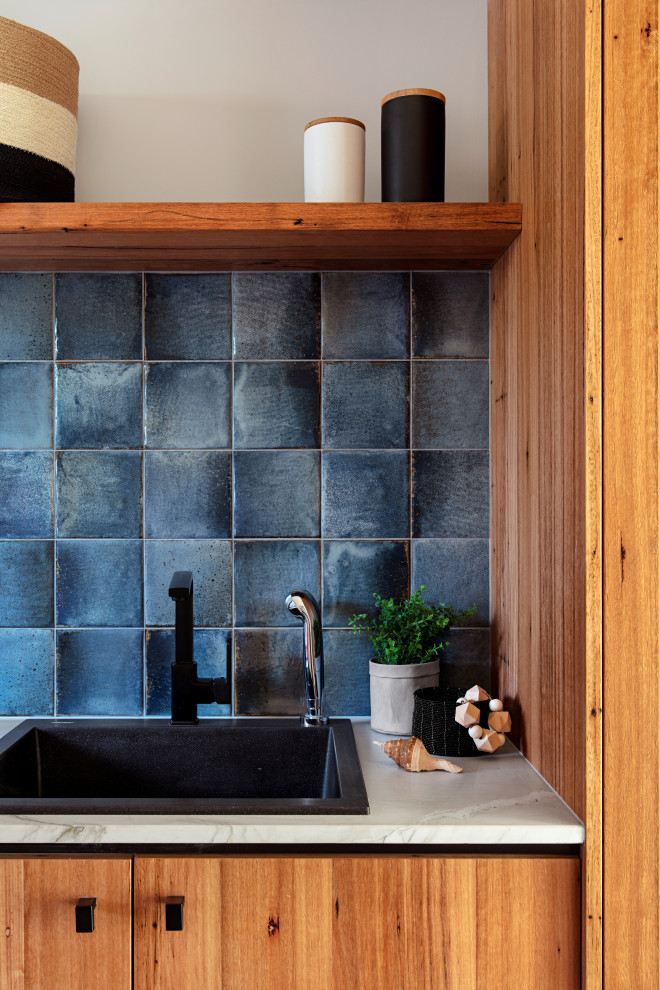 Idee per una sala lavanderia moderna di medie dimensioni con lavello da incasso, top in marmo, pareti blu e top grigio