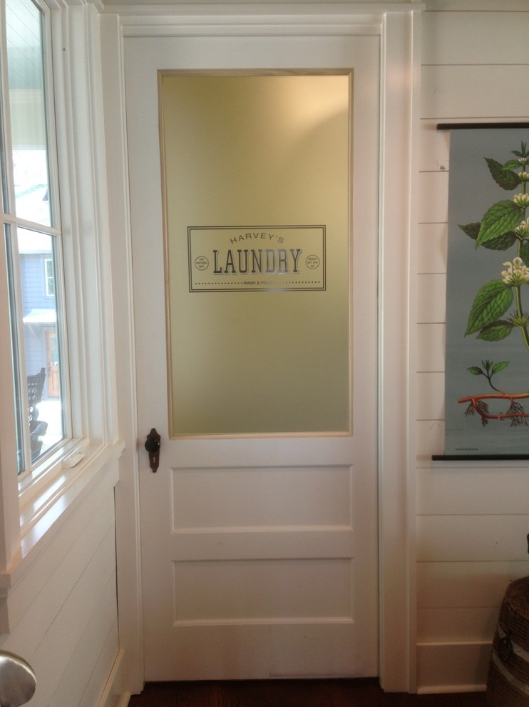 Large elegant medium tone wood floor dedicated laundry room photo in Atlanta with white walls