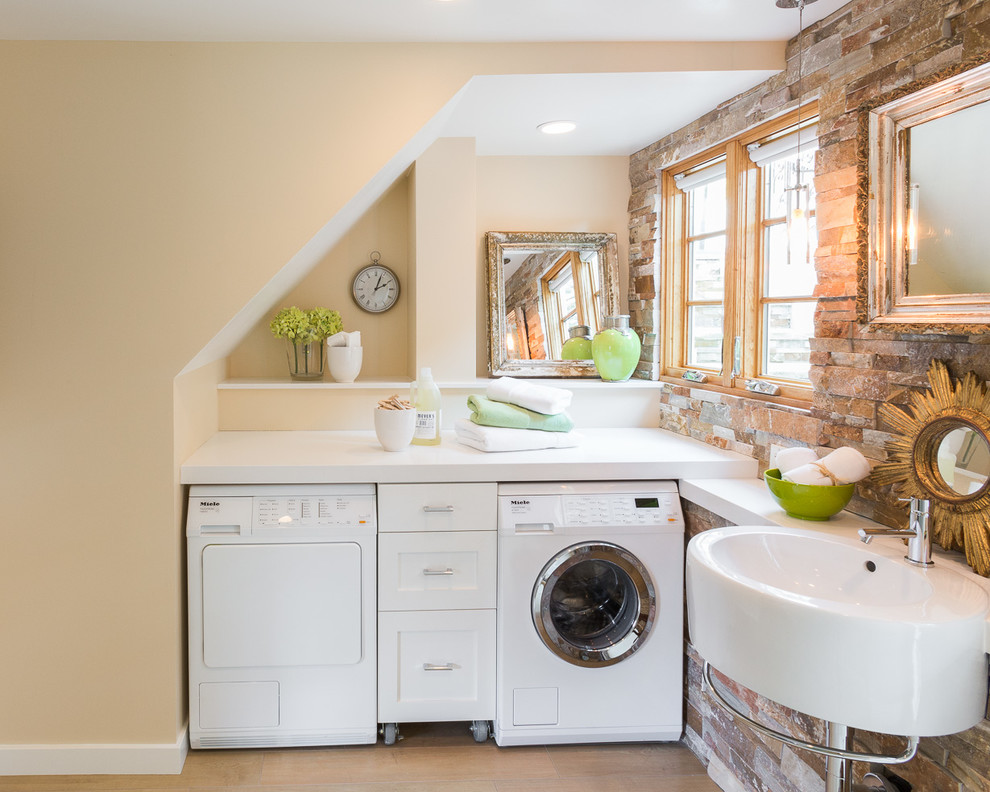 Classic l-shaped utility room in San Francisco with a single-bowl sink, recessed-panel cabinets, white cabinets, beige walls, a side by side washer and dryer and light hardwood flooring.