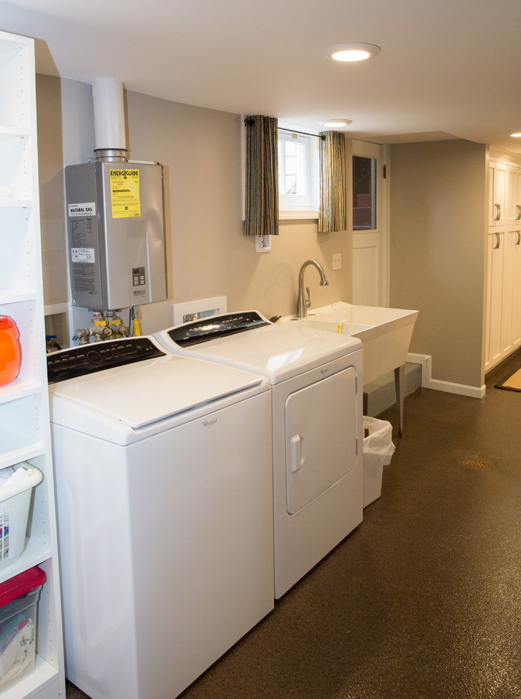 Laundry room - large traditional concrete floor and brown floor laundry room idea in Other with gray walls
