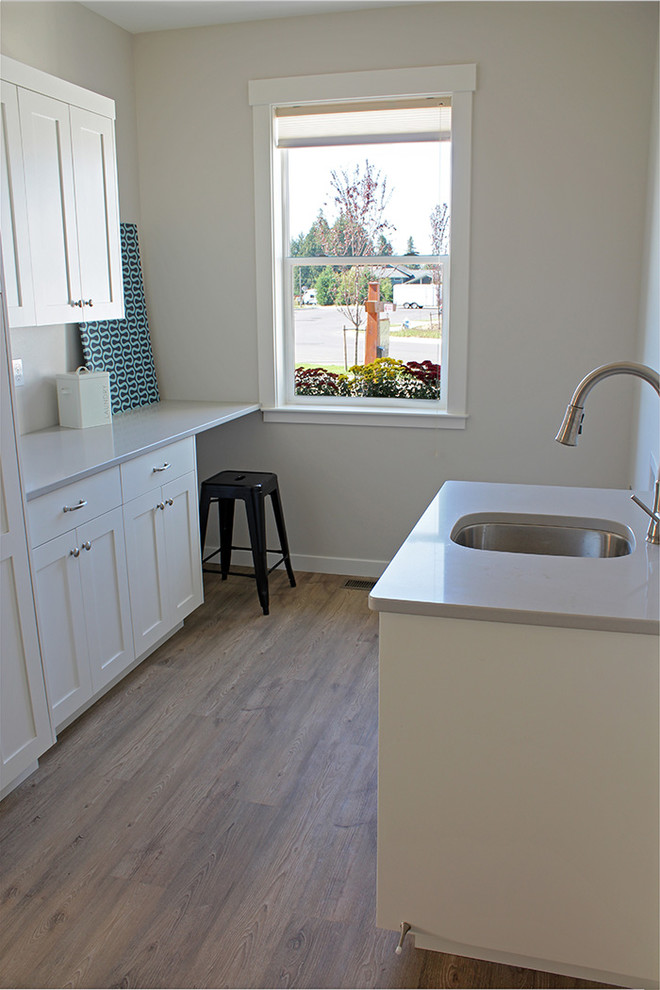 Large arts and crafts galley vinyl floor utility room photo in Seattle with an undermount sink, shaker cabinets, white cabinets, quartz countertops, gray walls and a side-by-side washer/dryer