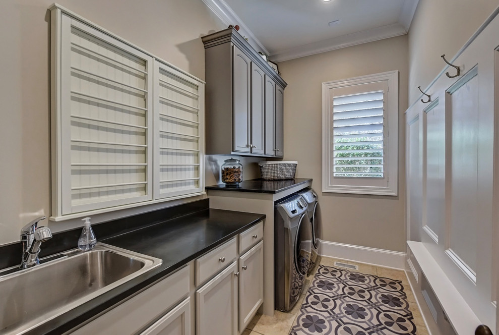 Small transitional galley ceramic tile and beige floor utility room photo in Charlotte with a drop-in sink, recessed-panel cabinets, gray cabinets, granite countertops, beige walls, a side-by-side washer/dryer and black countertops