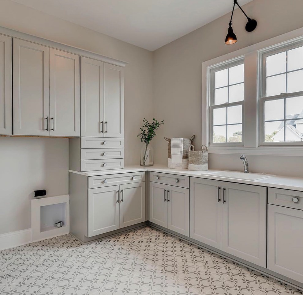 Photo of a traditional utility room in Indianapolis with a built-in sink, shaker cabinets, grey cabinets, engineered stone countertops, ceramic flooring and white worktops.