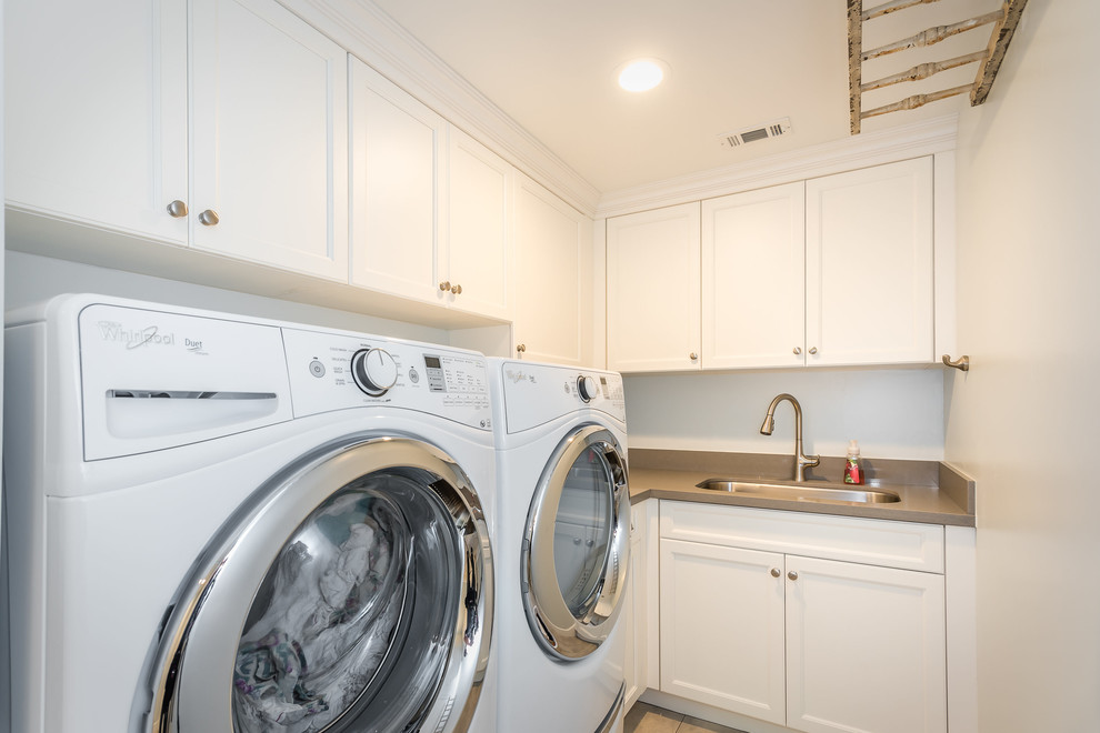 Inspiration for a small traditional u-shaped utility room in San Luis Obispo with an utility sink, shaker cabinets, white cabinets, engineered stone countertops, blue walls, ceramic flooring and a side by side washer and dryer.