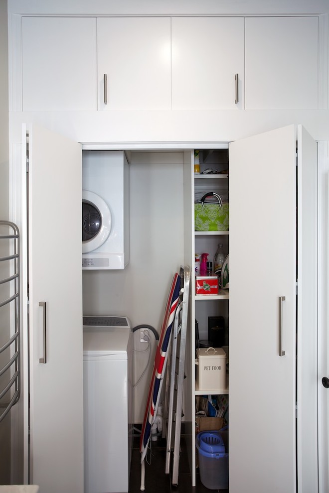 Small contemporary utility room in Auckland with flat-panel cabinets, grey walls, porcelain flooring and white cabinets.
