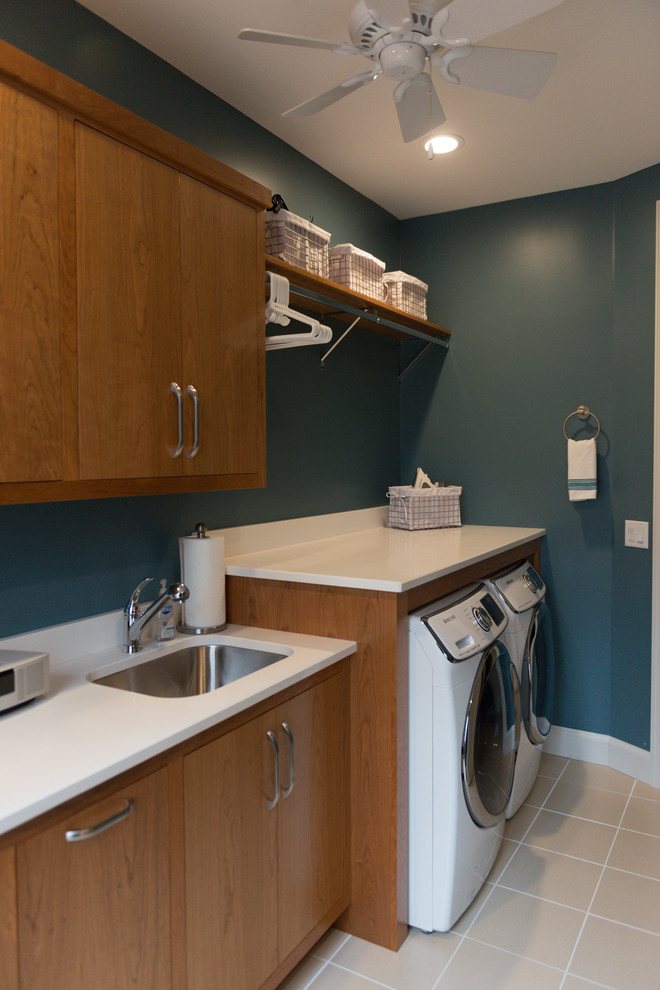 Large transitional u-shaped ceramic tile utility room photo in Chicago with a single-bowl sink, flat-panel cabinets, medium tone wood cabinets, quartz countertops, blue walls and a side-by-side washer/dryer