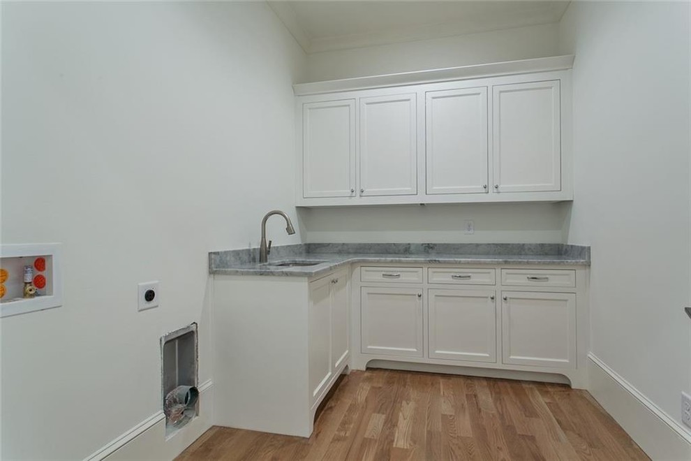 Large elegant u-shaped dedicated laundry room photo in Atlanta with recessed-panel cabinets, white cabinets, marble countertops, a side-by-side washer/dryer and gray countertops