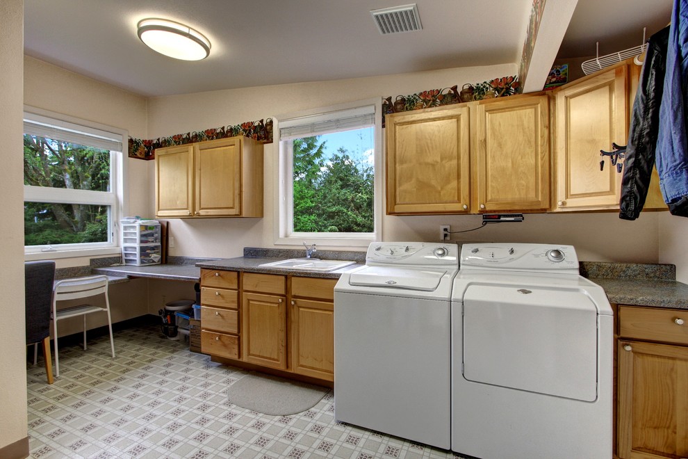 Utility room - large 1960s utility room idea in Seattle with a side-by-side washer/dryer