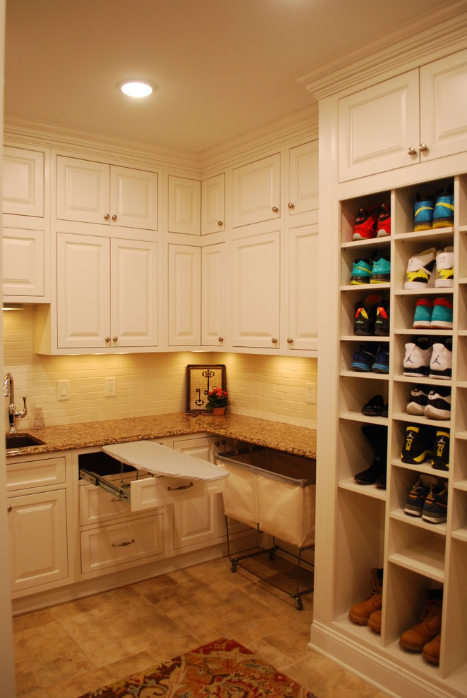 Large classic u-shaped utility room in Cleveland with a submerged sink, white cabinets, engineered stone countertops, yellow walls, porcelain flooring, a side by side washer and dryer and beaded cabinets.