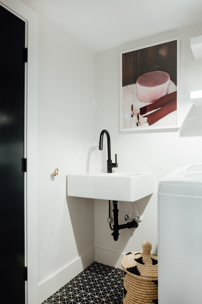 Small eclectic single-wall separated utility room in Salt Lake City with a submerged sink, white walls, porcelain flooring and black floors.