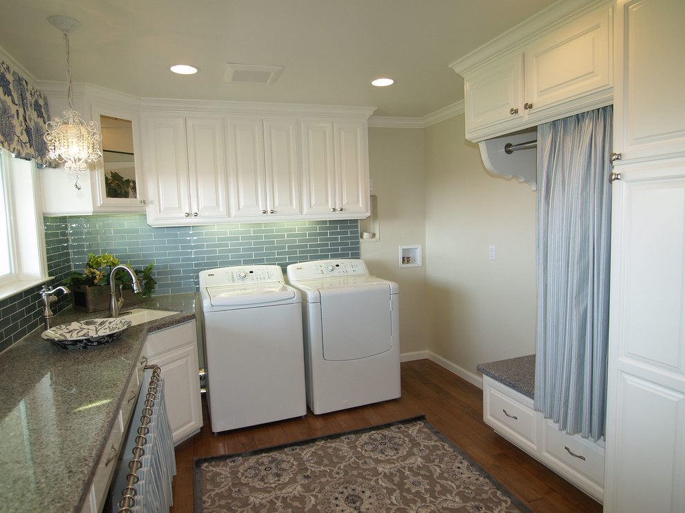 Inspiration for a large timeless u-shaped medium tone wood floor utility room remodel in Sacramento with an undermount sink, raised-panel cabinets, white cabinets, solid surface countertops, beige walls and a side-by-side washer/dryer
