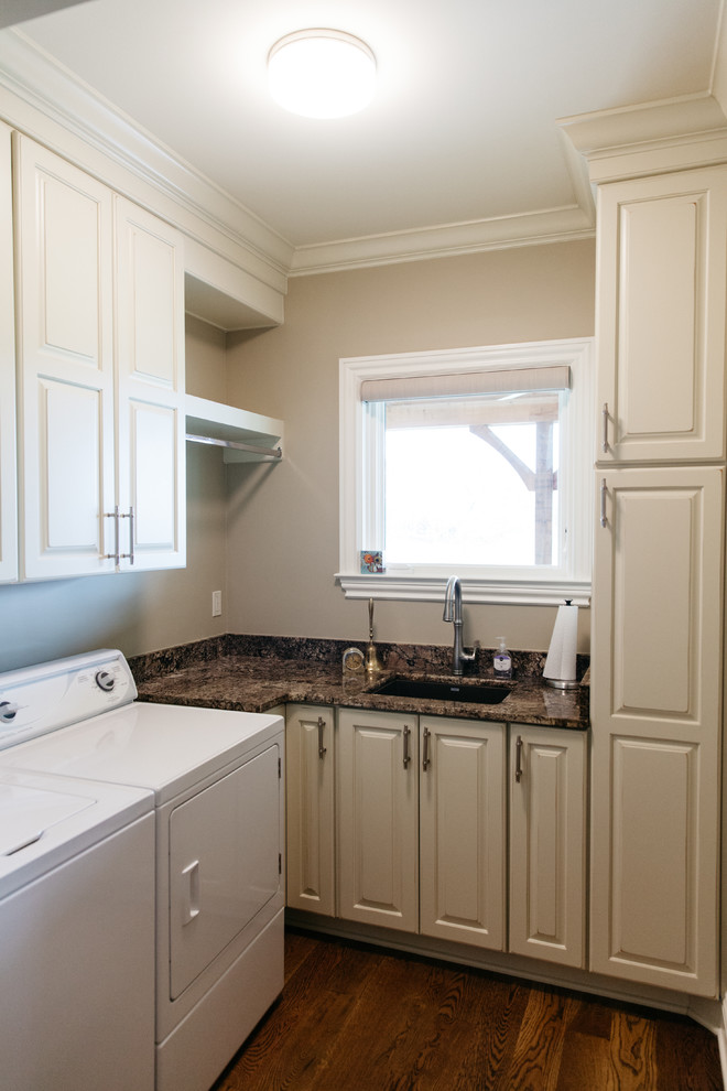 Inspiration for a timeless l-shaped medium tone wood floor laundry room remodel in Nashville with raised-panel cabinets, white cabinets, granite countertops and a single-bowl sink
