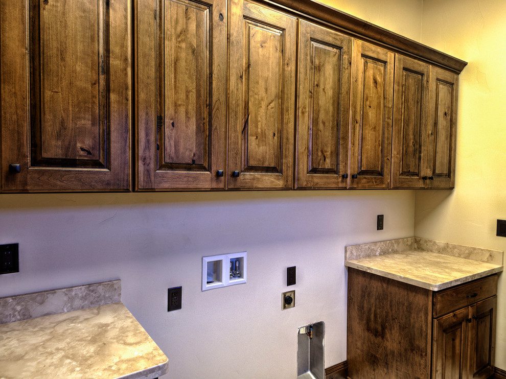 Large rustic galley separated utility room in Other with a built-in sink, raised-panel cabinets, dark wood cabinets, granite worktops, beige walls, lino flooring and a side by side washer and dryer.
