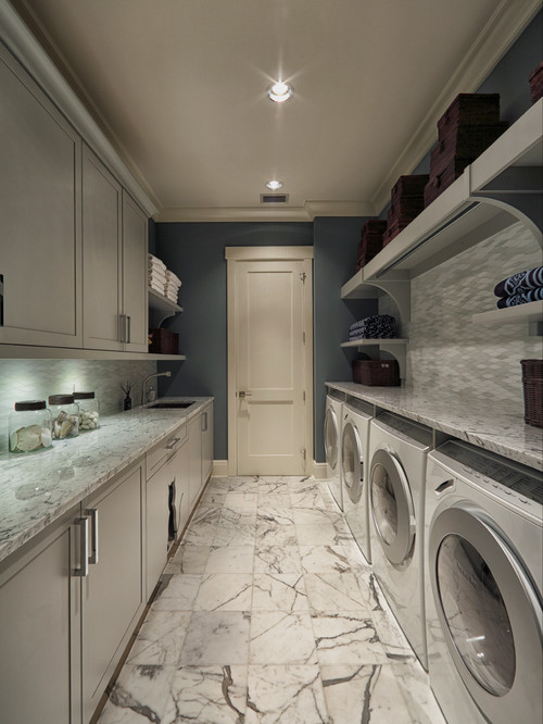 Laundry room - transitional gray floor laundry room idea in Miami with gray cabinets 