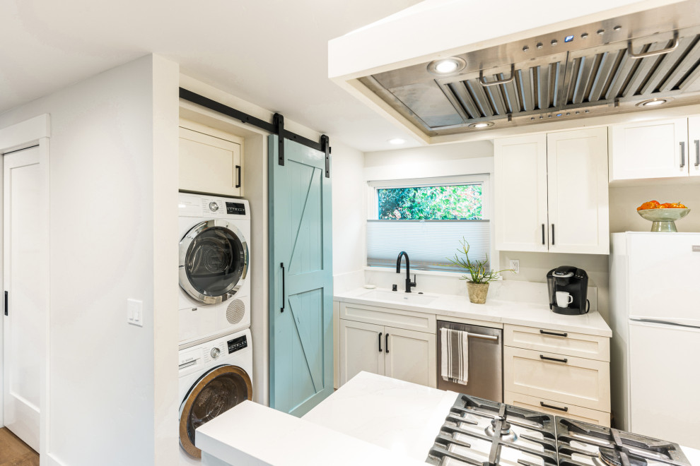 Stacked Washer and Dryer in Hidden Laundry Closet with Sliding Barn