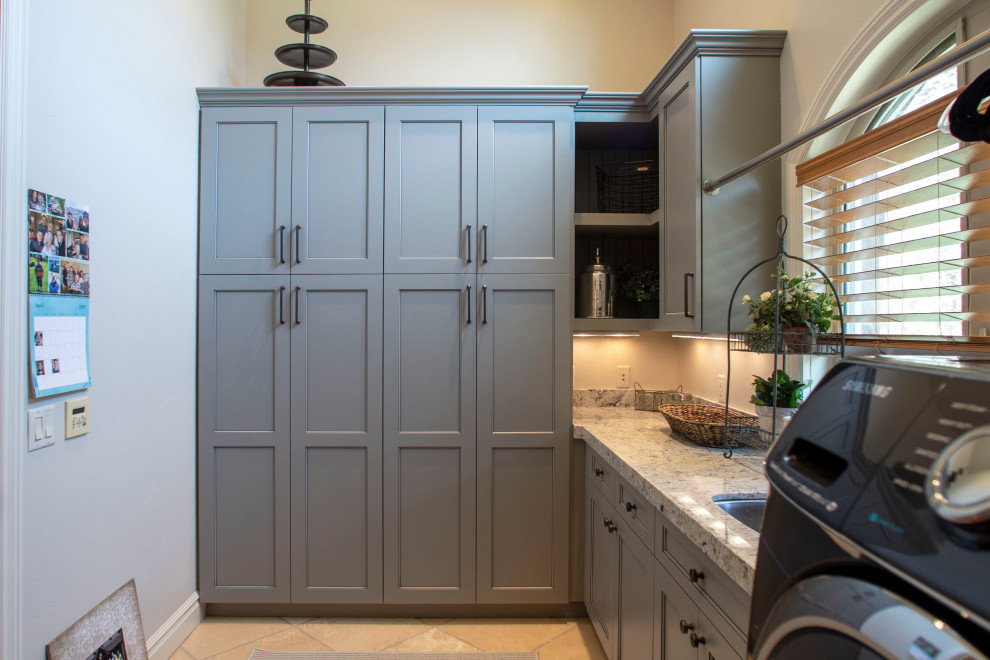 Inspiration for a mid-sized l-shaped laundry room remodel in Salt Lake City with an undermount sink, shaker cabinets, gray cabinets, granite countertops, multicolored backsplash, granite backsplash, a side-by-side washer/dryer and multicolored countertops