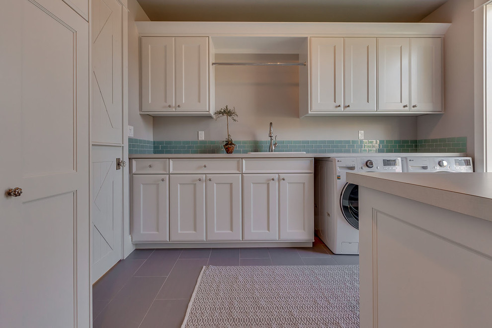 Photo of a medium sized contemporary utility room in Boise with a built-in sink, white cabinets, laminate countertops, grey walls, a side by side washer and dryer and recessed-panel cabinets.