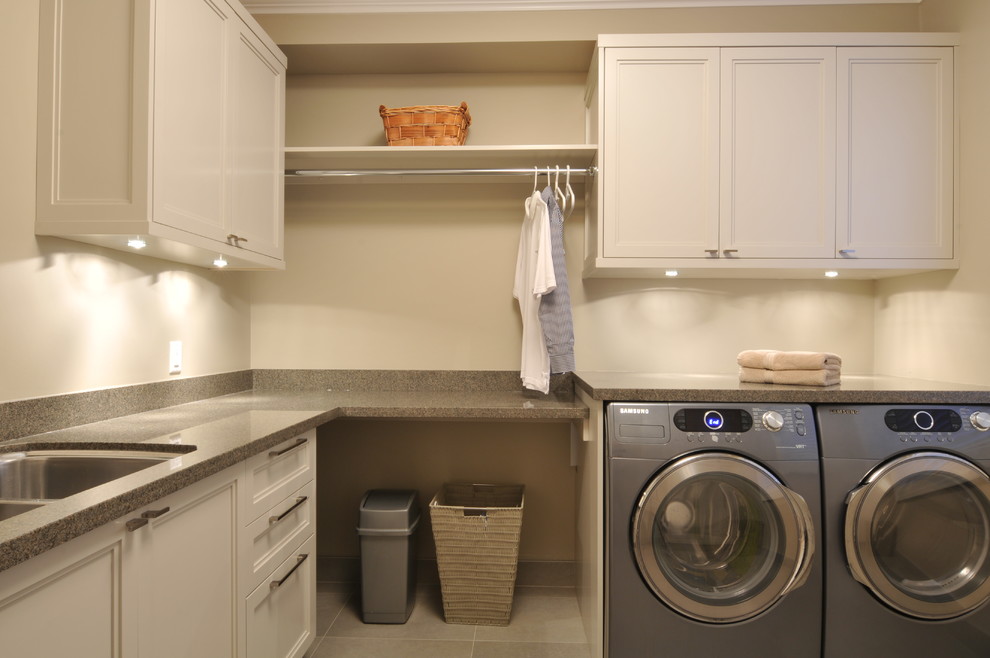 Große Klassische Waschküche in L-Form mit Unterbauwaschbecken, Schrankfronten im Shaker-Stil, weißen Schränken, Granit-Arbeitsplatte, Keramikboden und Waschmaschine und Trockner nebeneinander in Vancouver