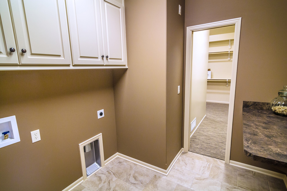 Inspiration for a classic separated utility room in Kansas City with raised-panel cabinets, white cabinets, laminate countertops, beige walls, ceramic flooring and a side by side washer and dryer.