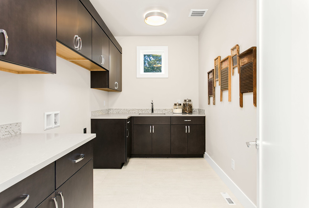 Design ideas for a large modern l-shaped separated utility room in Seattle with an utility sink, flat-panel cabinets, dark wood cabinets, engineered stone countertops, grey walls, ceramic flooring and a side by side washer and dryer.