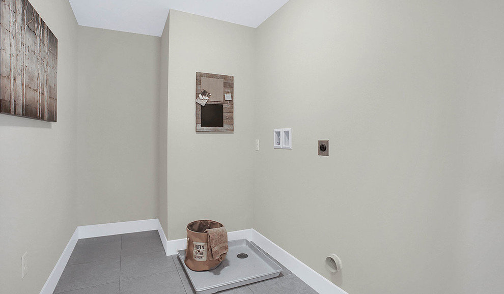 Large traditional single-wall separated utility room in Other with grey walls, vinyl flooring, a side by side washer and dryer and grey floors.