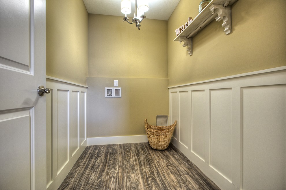 Example of a classic galley linoleum floor dedicated laundry room design in Grand Rapids with beige walls and a side-by-side washer/dryer