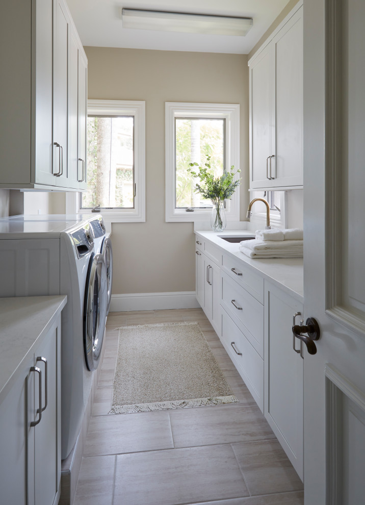 Inspiration for a medium sized traditional galley separated utility room with a submerged sink, recessed-panel cabinets, white cabinets, quartz worktops, beige walls, porcelain flooring, a side by side washer and dryer, beige floors and white worktops.